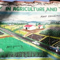 Mural of a person spraying a field next to the words 'food security' and 'pest control'